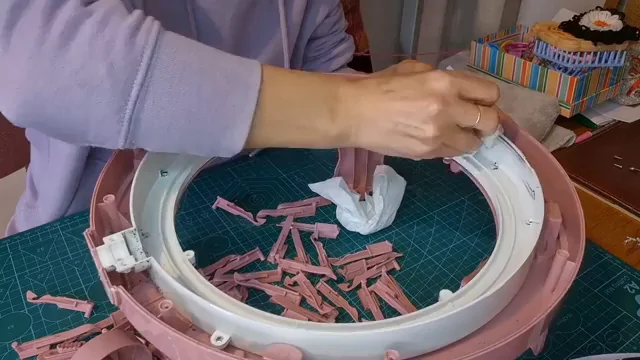 How to Clean and Lubricate Your Sentro Knitting Machine 2 Wiping down the disassembled white ring of a Sentro machine during cleaning